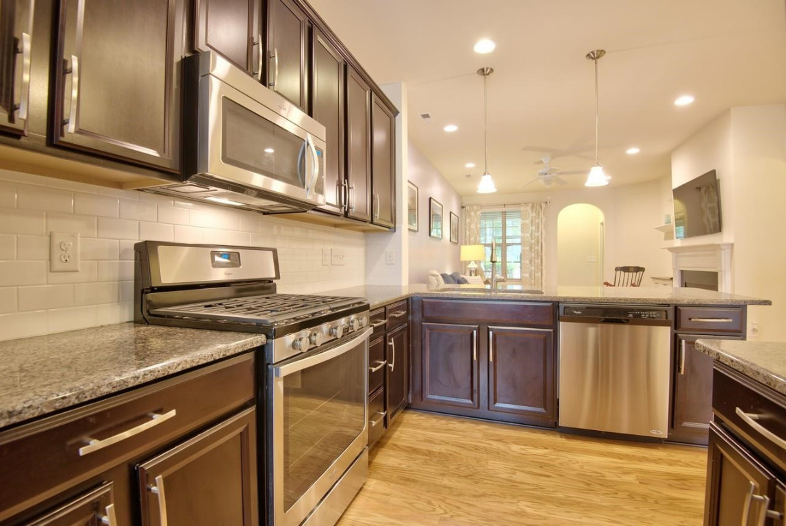 Undisclosed Address Durham, NC 27705 - Photo 5 of 25 a kitchen with stainless steel appliances granite countertop a stove a sink and a microwave