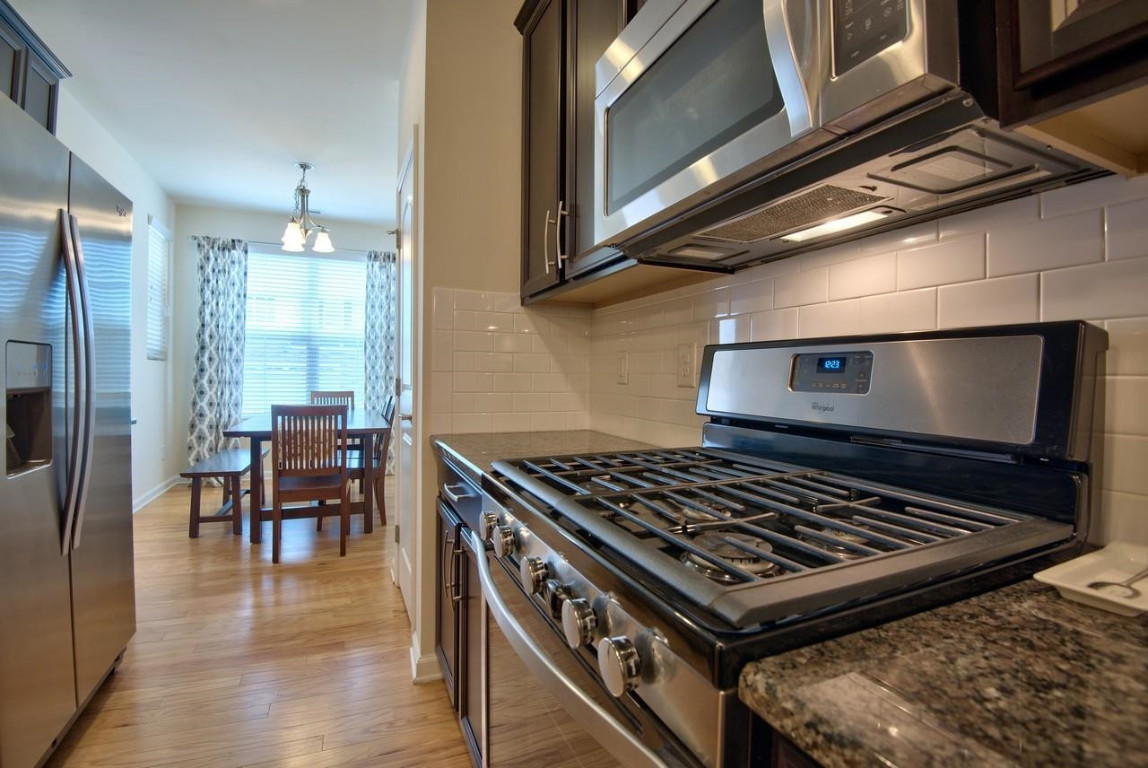 Undisclosed Address Durham, NC 27705 - Photo 6 of 25 a stove top oven sitting inside of a kitchen