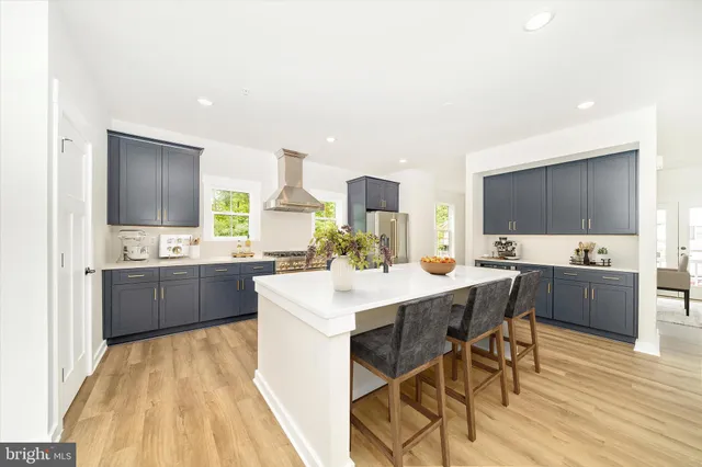 a kitchen with stainless steel appliances granite countertop a stove a refrigerator and a refrigerator