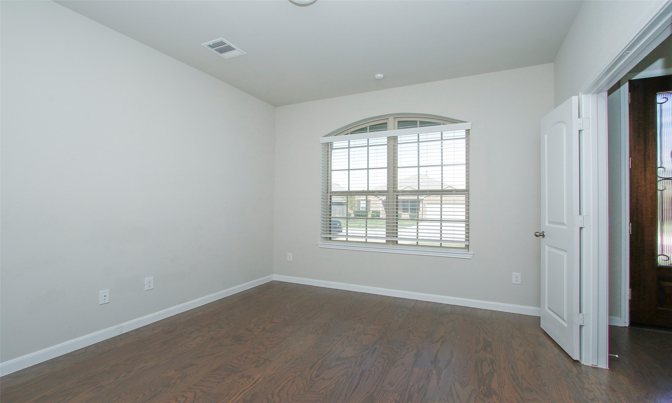 14120 Sand Ridge Court Conroe, TX 77384 - Photo 6 of 43 an empty room with wooden floor and windows