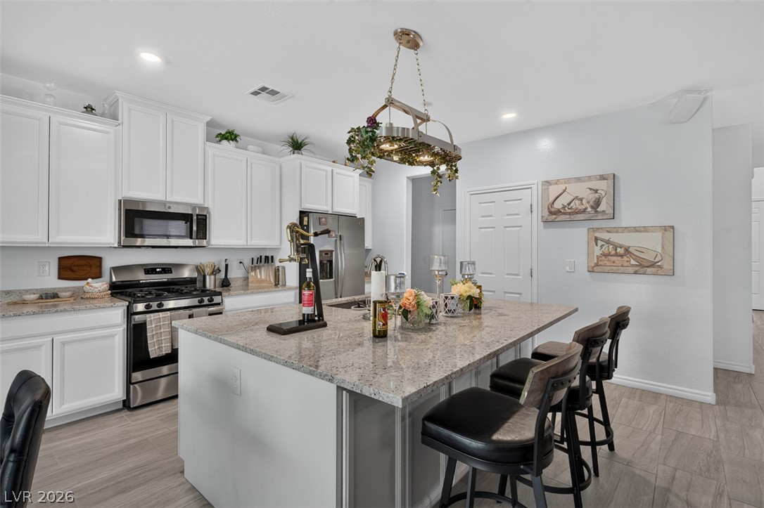 1824 Redland Ridge Street Henderson, NV 89002 - Photo 17 of 69 Culinary delights await in this bright kitchen, complete with a generous island and sleek appliances.