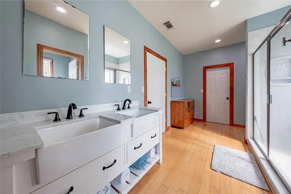 a bathroom with a double vanity sink and mirror