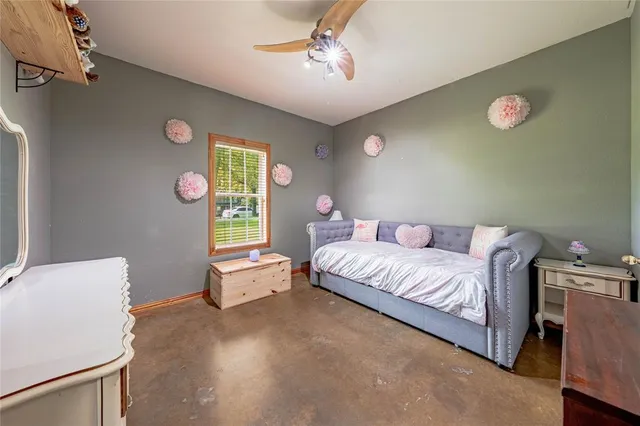 a spacious bedroom with a bed and a window