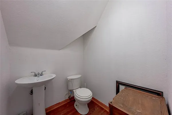 a white toilet sitting next to a bathroom sink