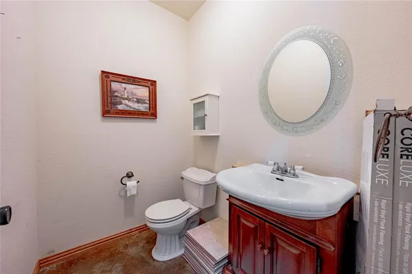 a bathroom with a toilet a sink and mirror
