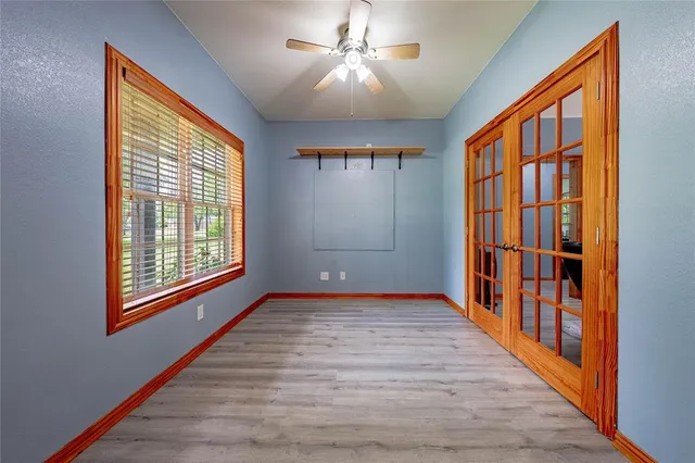 a view of empty room with window and wooden floor