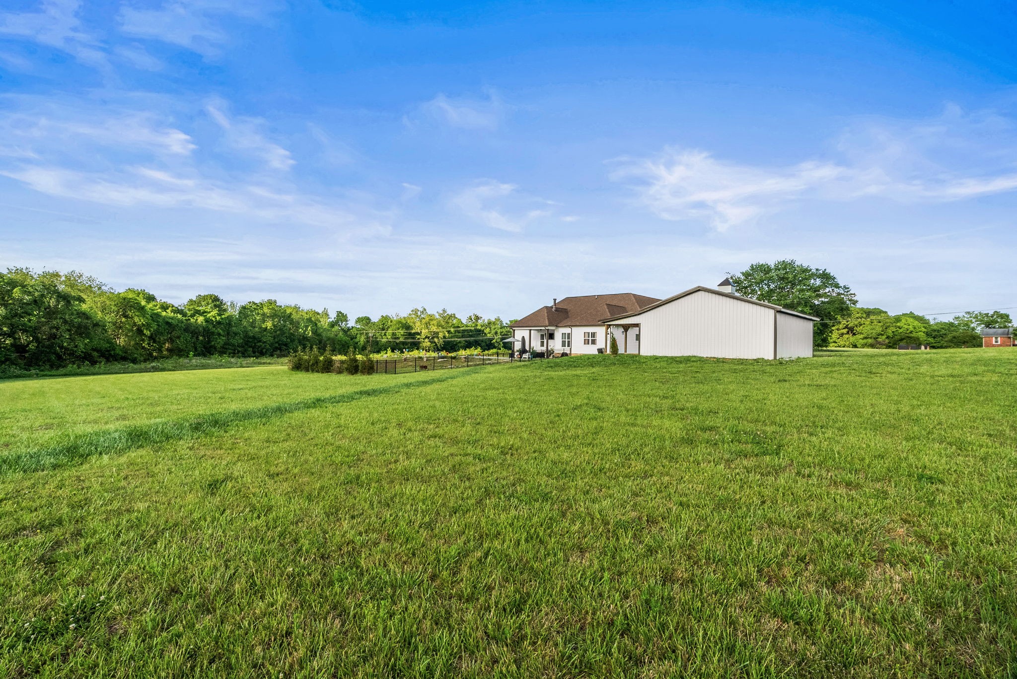 3378 New Hall Road Greenbrier, TN 37073 - Photo 78 of 83 a view of a garden with a building in the background