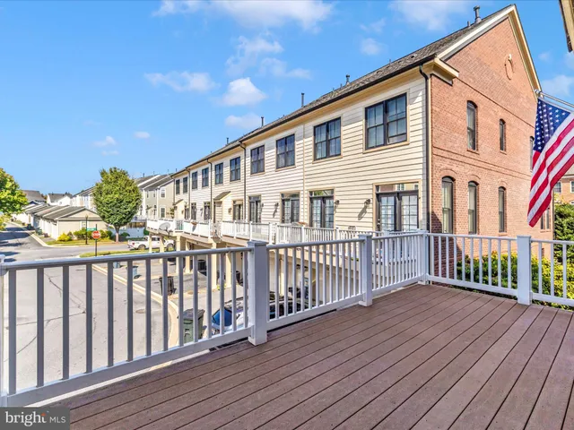 a kitchen with stainless steel appliances granite countertop a sink a stove and a wooden cabinets