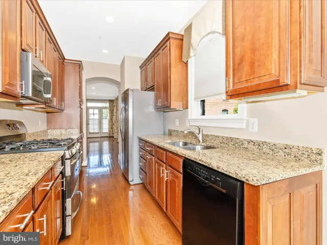 a view of a livingroom with a window and a ceiling fan