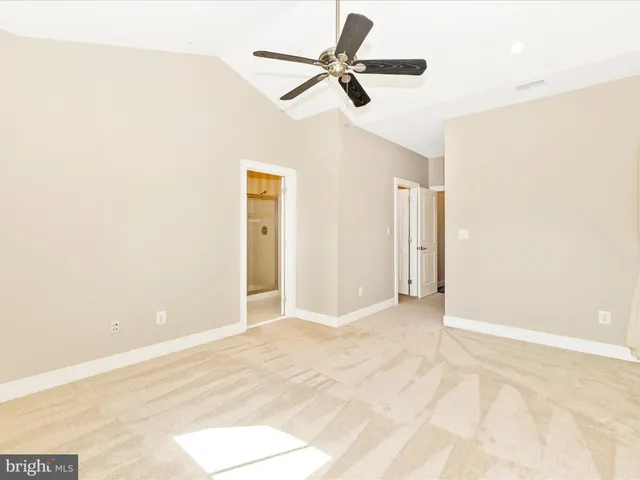 a view of a room with a ceiling fan