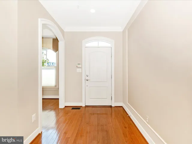 a view of empty room with wooden floor and fireplace