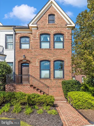 an outdoor sitting area with furniture and umbrella
