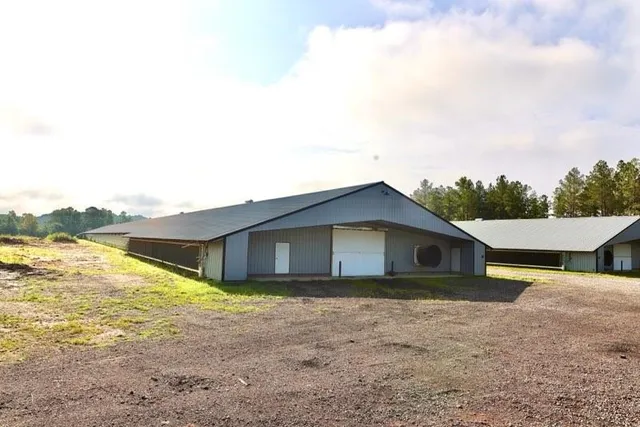 a view of a house with pool and yard