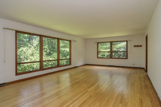 41-w393 Farview Road Elburn, IL 60119 - Photo 5 of 24 a view of an empty room with a window and wooden floor