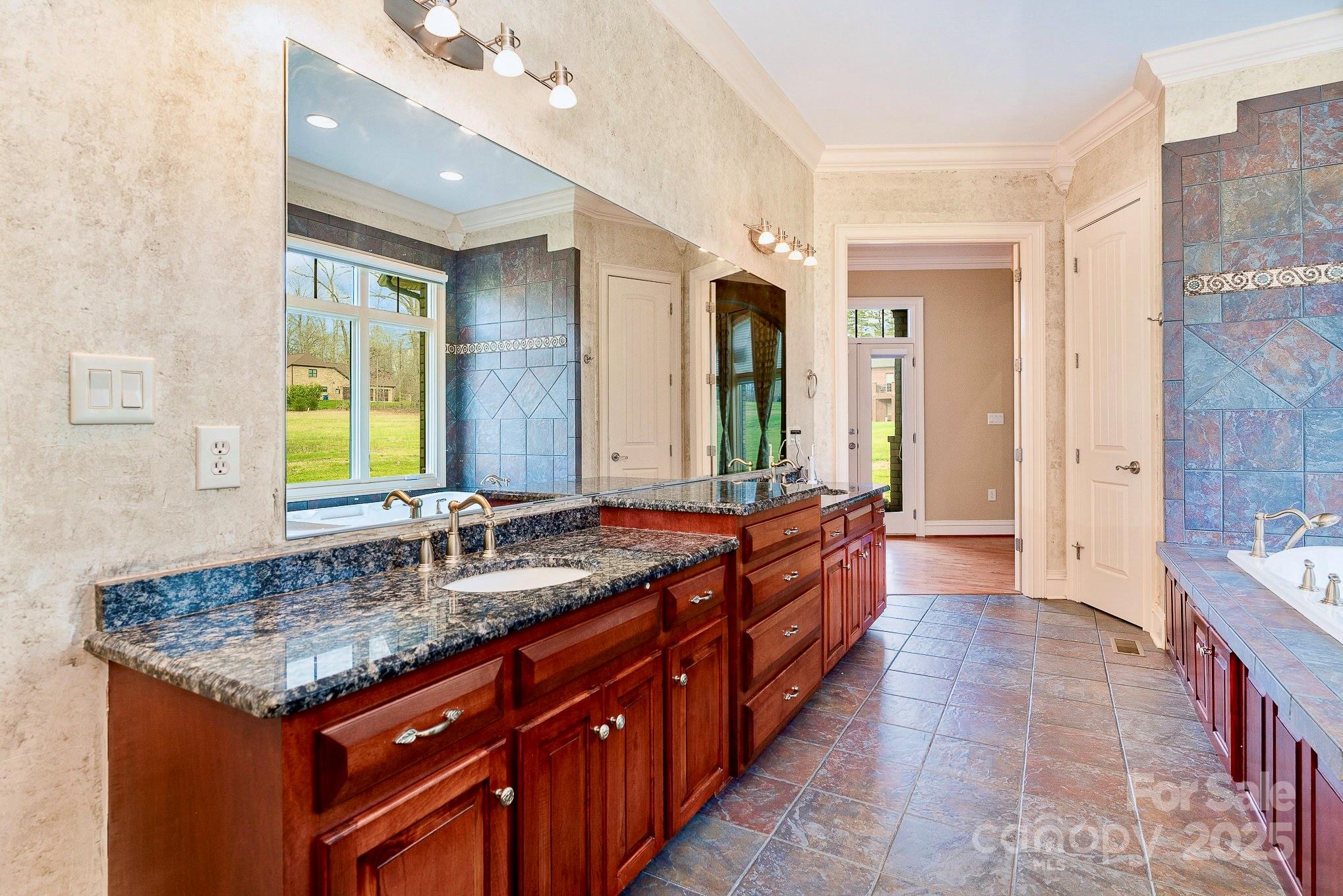 520 Riviera Drive Salisbury, NC 28144 - Photo 17 of 34 a spacious bathroom with a granite countertop double vanity sink a mirror and a bathtub