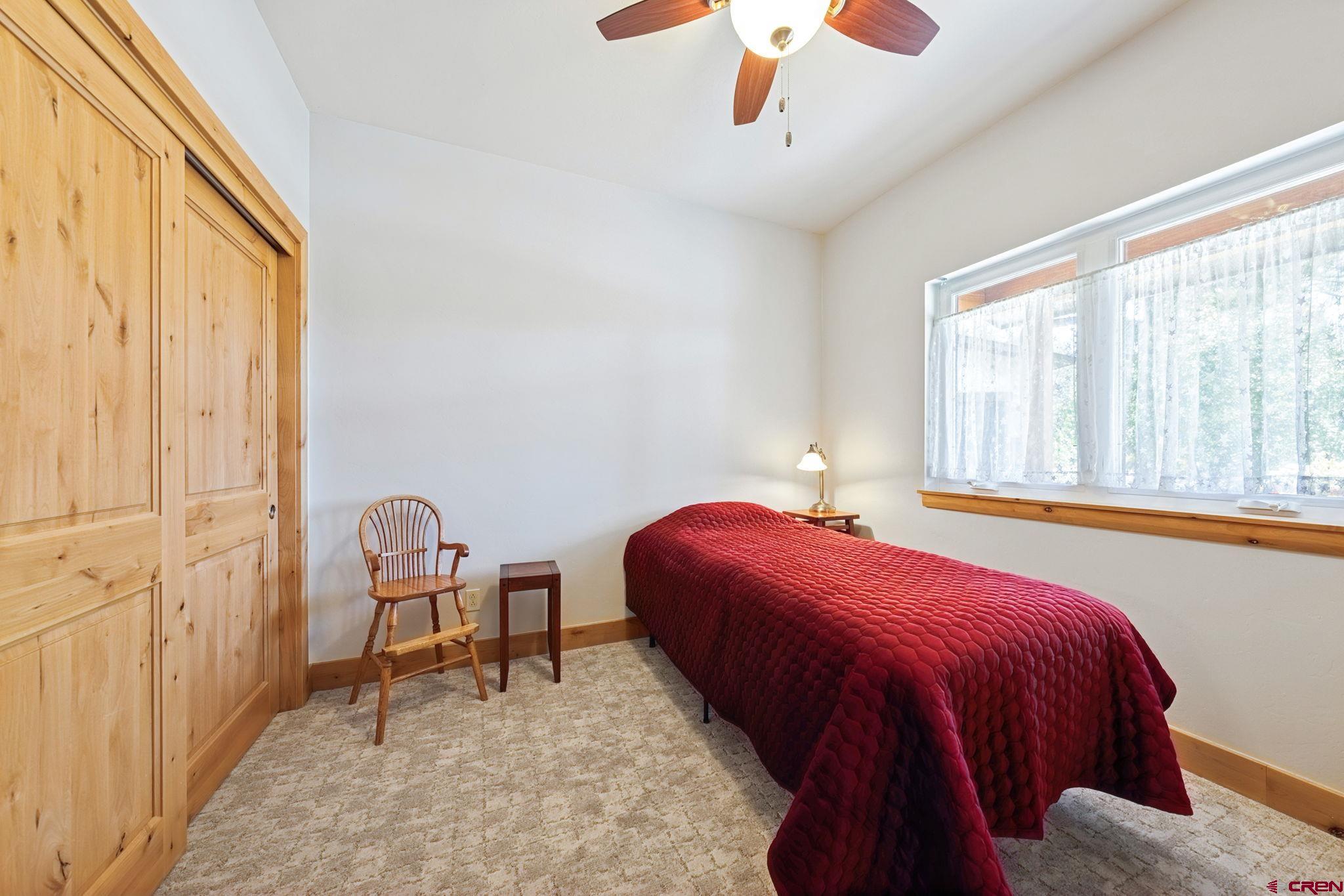 67 Mountain Stream Court Durango, CO 81301 - Photo 28 of 35 a bedroom with a bed and a window