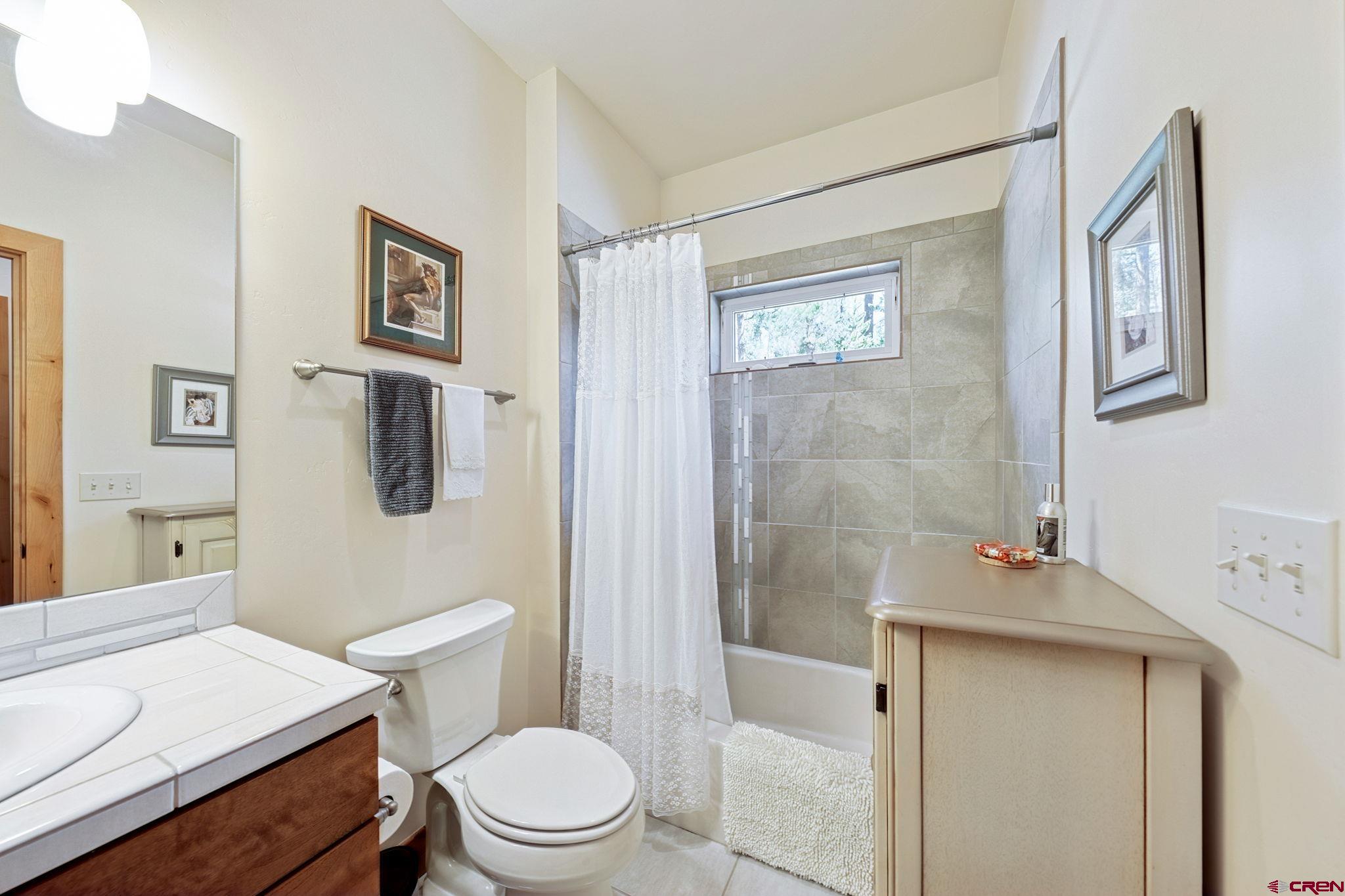 67 Mountain Stream Court Durango, CO 81301 - Photo 31 of 35 a bathroom with a sink a toilet and shower