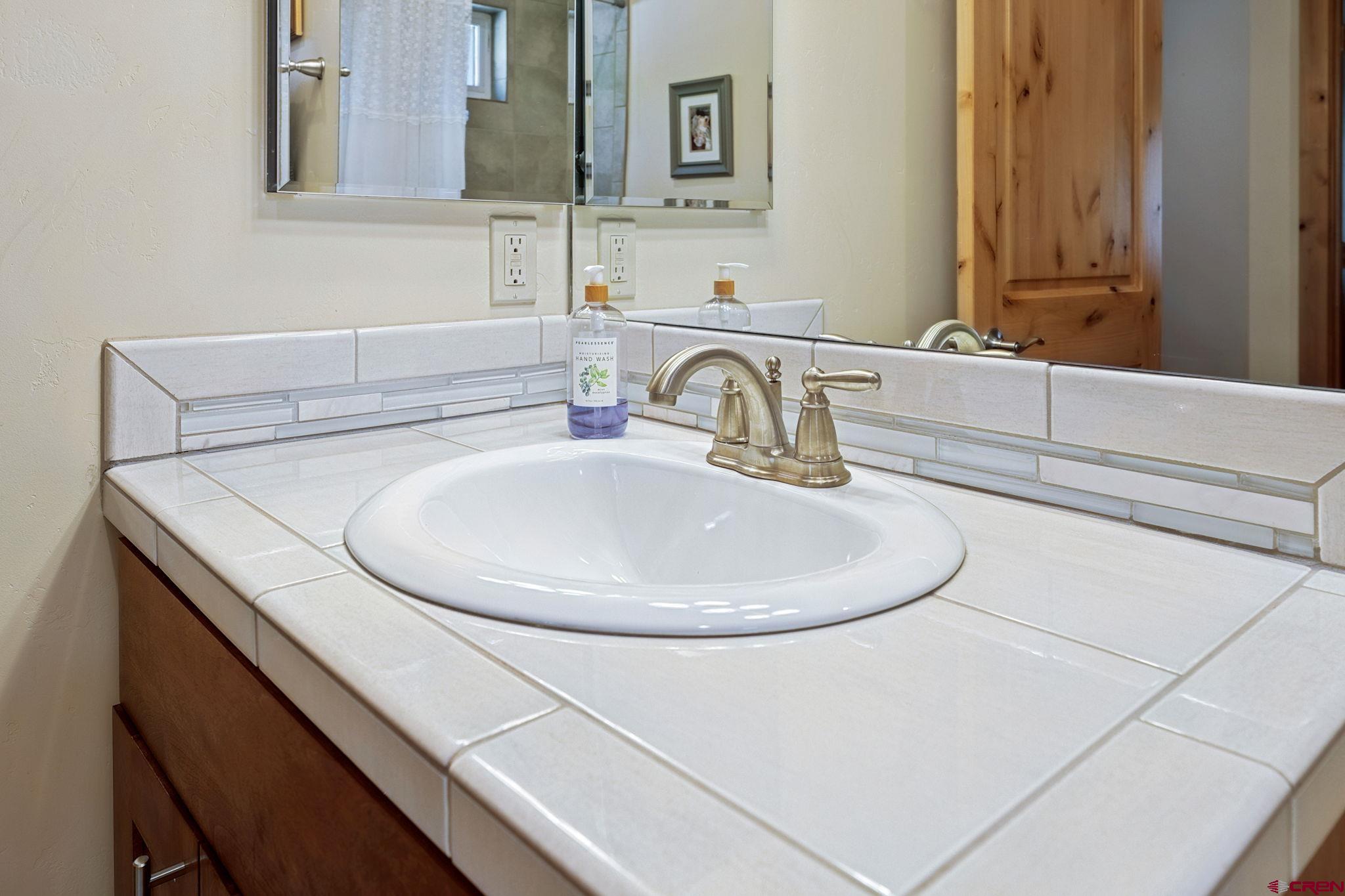 67 Mountain Stream Court Durango, CO 81301 - Photo 32 of 35 a bathroom with a sink and a mirror