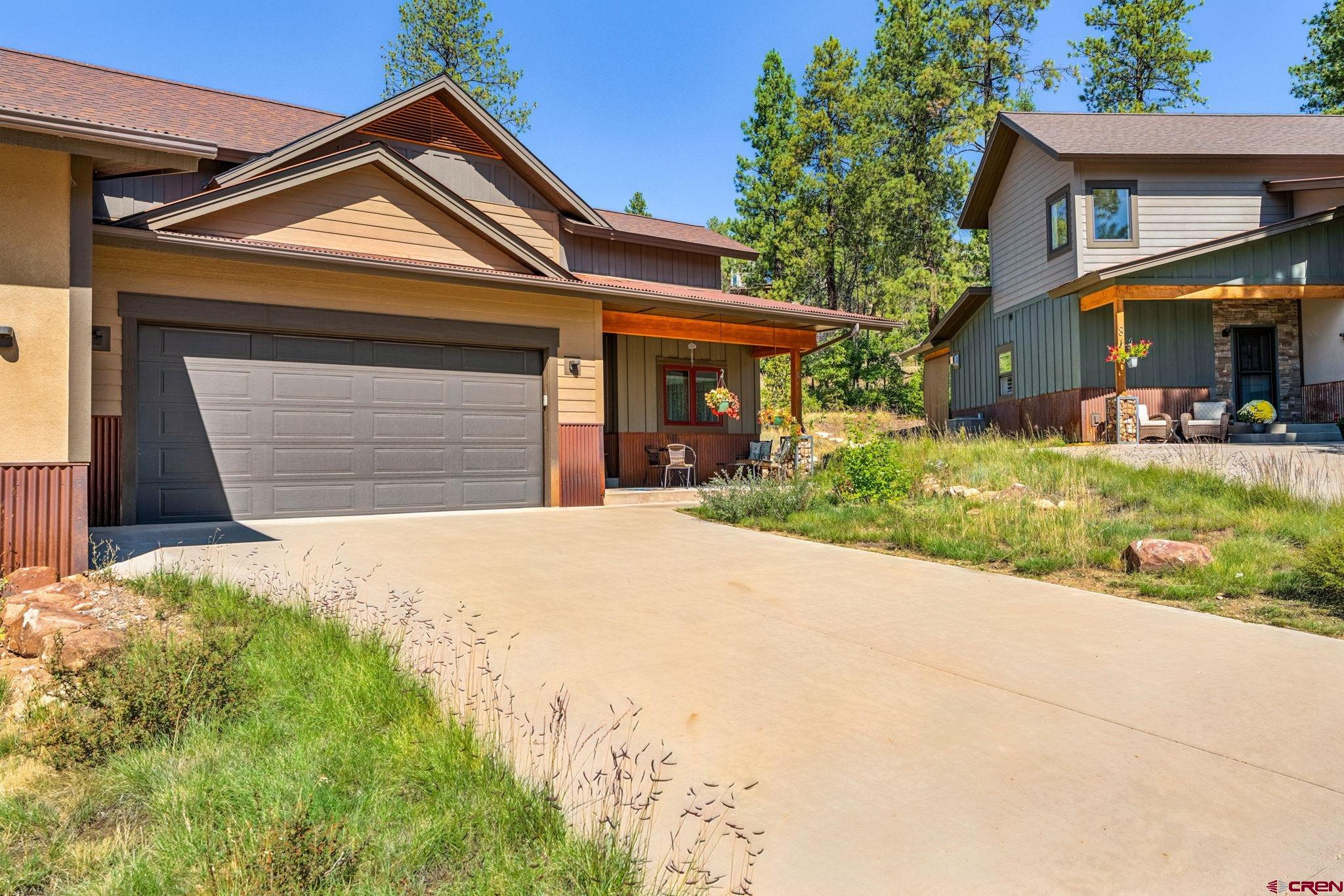 67 Mountain Stream Court Durango, CO 81301 - Photo 34 of 35 a front view of a house with a yard and garage