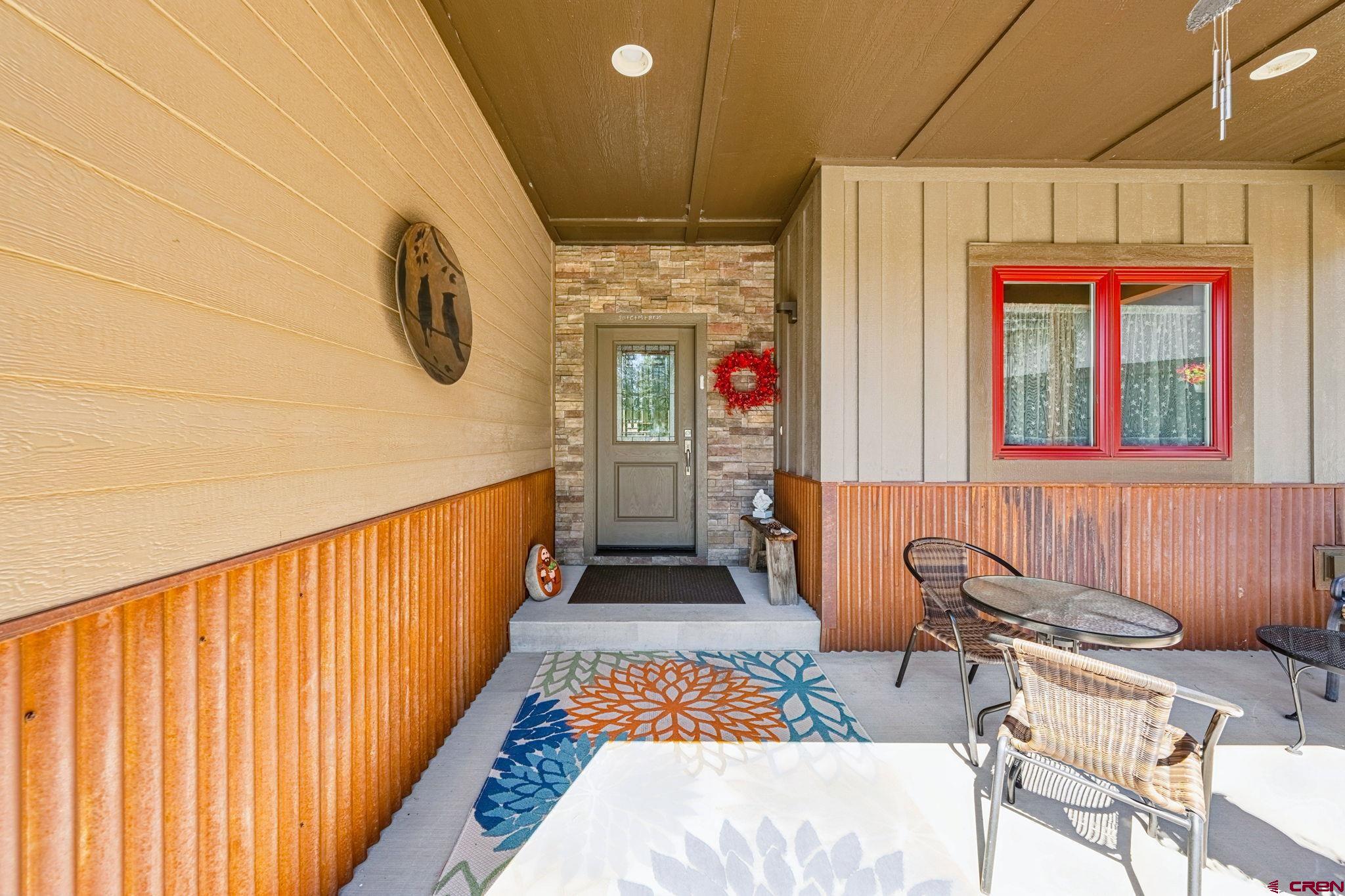 67 Mountain Stream Court Durango, CO 81301 - Photo 5 of 35 a hallway with a table and chairs
