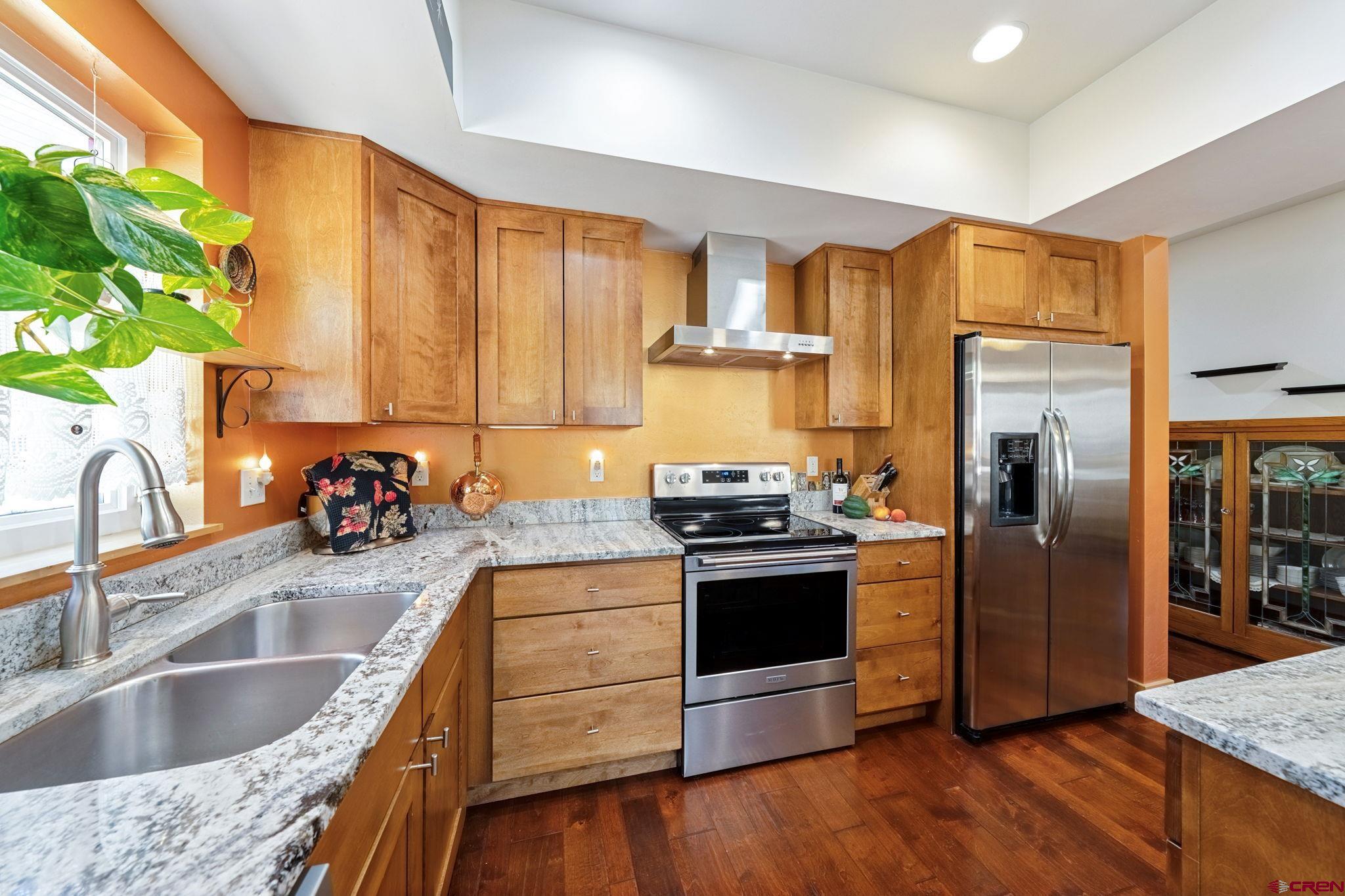 67 Mountain Stream Court Durango, CO 81301 - Photo 8 of 35 a kitchen with granite countertop a sink cabinets and stainless steel appliances