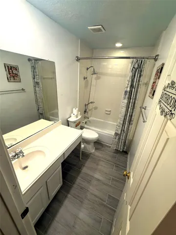 a bathroom with a tub sink and mirror