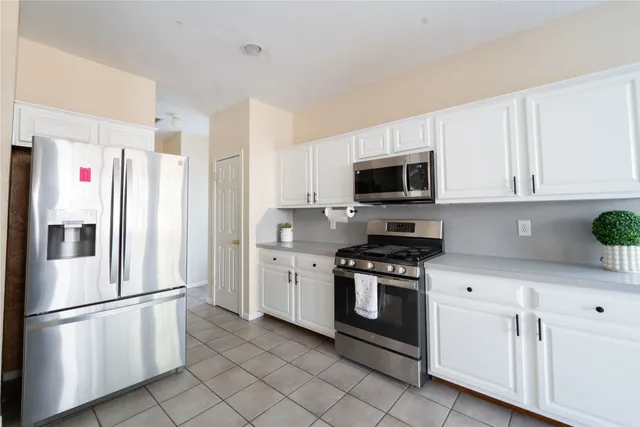 a white refrigerator freezer sitting in a kitchen