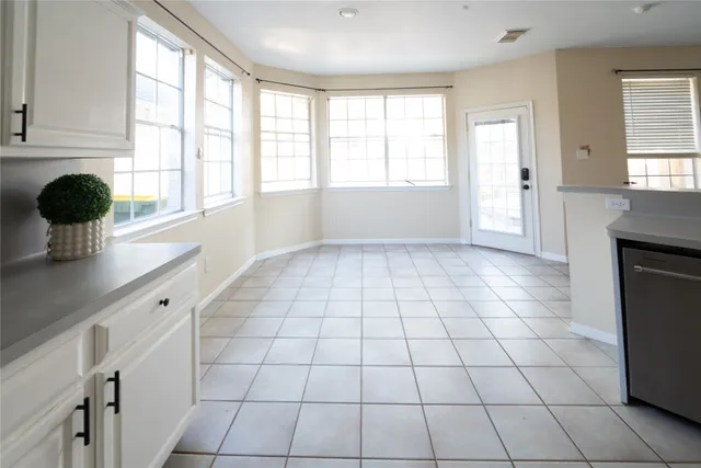 a view of a kitchen with windows and cabinet