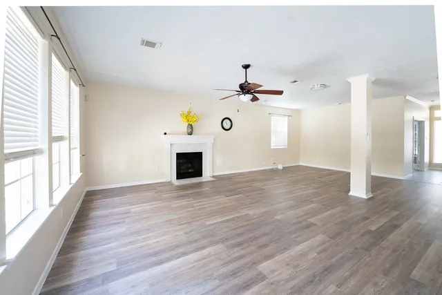 a view of a livingroom with wooden floor and window