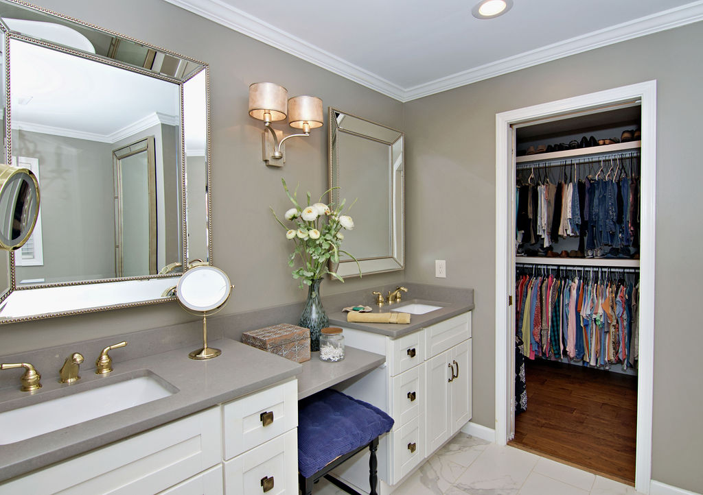11001 Lake Ridge Lane Seneca, SC 29672 - Photo 28 of 50 Crown molding and stone counters elevate this elegant dual-sink vanity space with a walk-in closet.