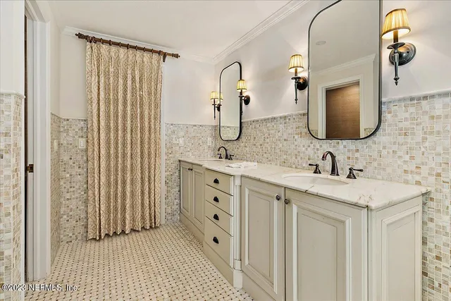 a bathroom with a double vanity sink and a mirror