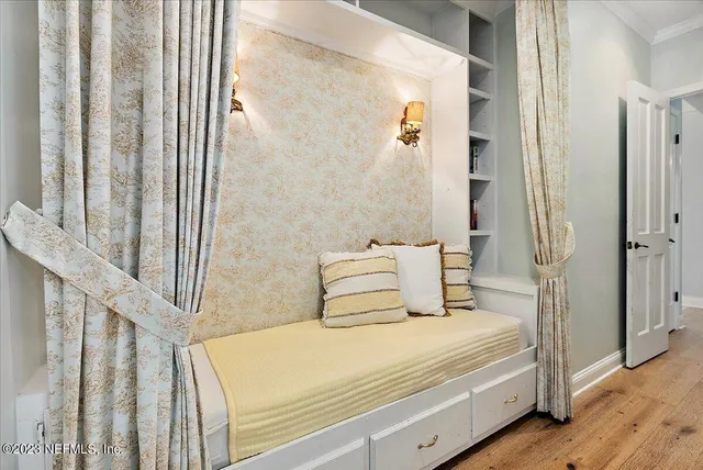 a bedroom with a bed and wooden floor