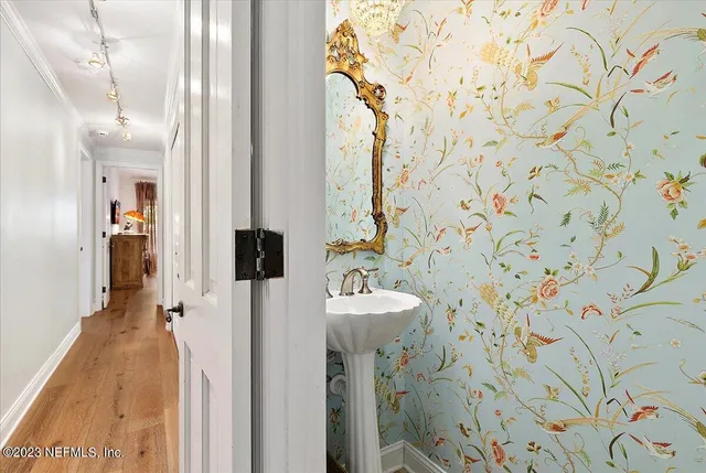 a bathroom with a sink and mirror with toilet