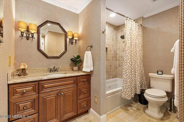a bathroom with a toilet a sink and a mirror