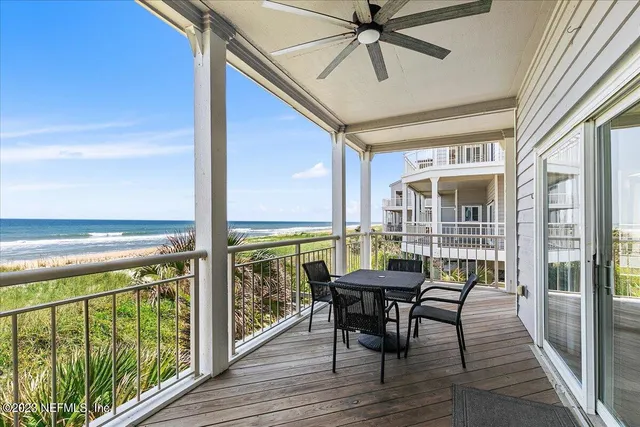 a view of a balcony with furniture and wooden floor