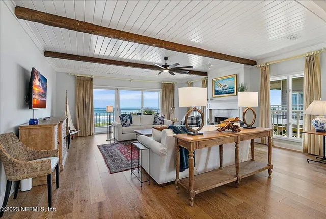 a living room with fireplace furniture and a wooden floor