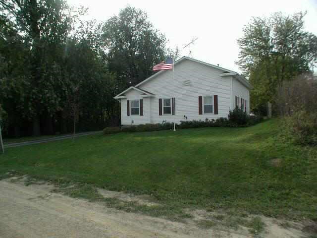 9478 North Excelsior Road Lena, IL 61048 - Photo 8 of 9 a view of a house with a yard and a garden