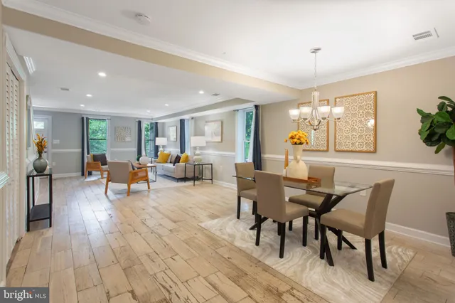 a view of a dining room with furniture window and wooden floor