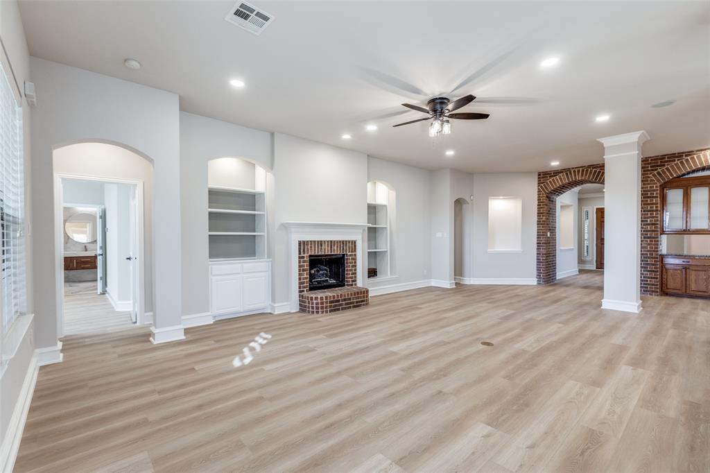 4009 Muscovy Drive McKinney, TX 75072 - Photo 14 of 31 an empty room with windows and a fireplace