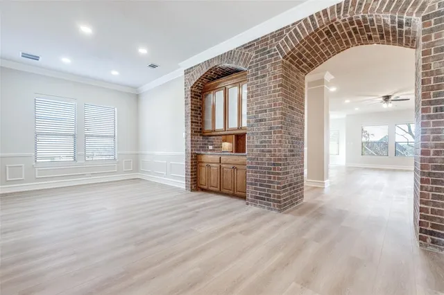 a large kitchen with stainless steel appliances granite countertop a stove sink and cabinets