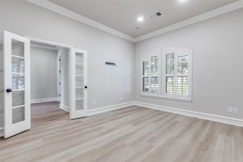4009 Muscovy Drive McKinney, TX 75072 - Photo 6 of 31 an empty room with wooden floor and windows