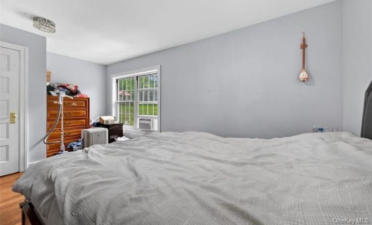 556 Lakes Road Monroe, NY 10950 - Photo 14 of 22 Bedroom with radiator heating unit and wood finished floors