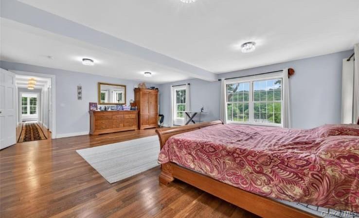 556 Lakes Road Monroe, NY 10950 - Photo 16 of 22 Bedroom with multiple windows, wood finished floors, and beam ceiling
