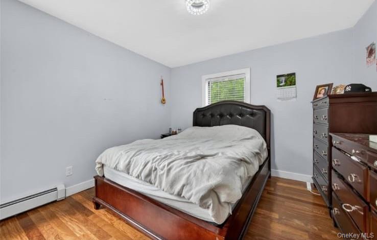 556 Lakes Road Monroe, NY 10950 - Photo 17 of 22 Bedroom featuring dark wood-style flooring and a baseboard radiator