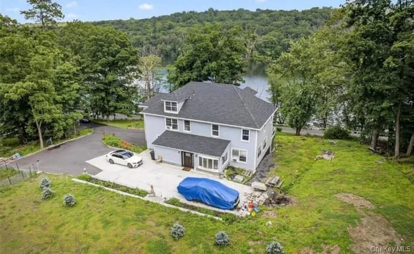 an aerial view of residential house with outdoor space and trees around