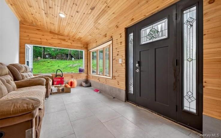 556 Lakes Road Monroe, NY 10950 - Photo 4 of 22 Entryway with lofted ceiling, wood walls, and wooden ceiling