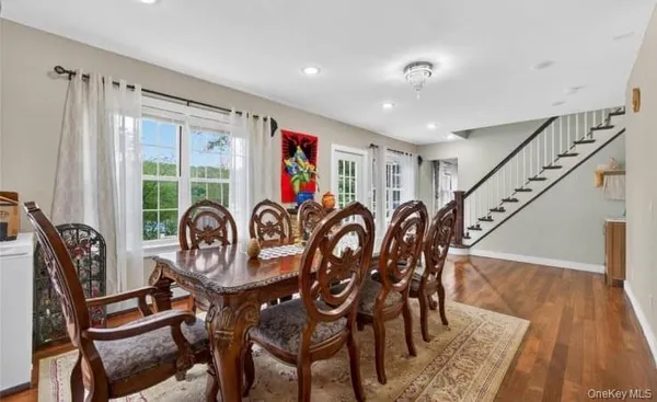 a view of a dining room with furniture window and wooden floor