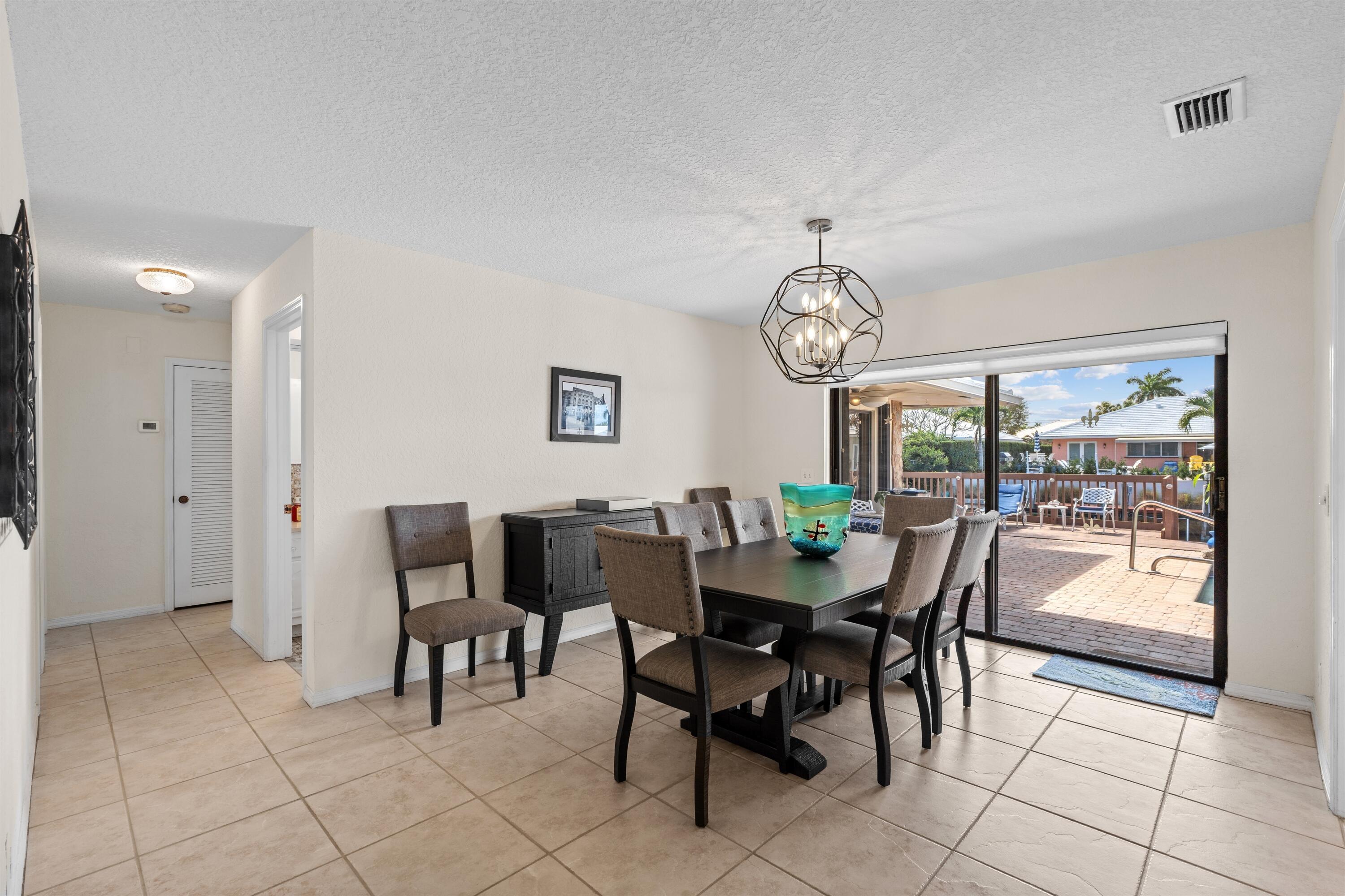 1223 Pepperridge Terrace Boca Raton, FL 33486 - Photo 13 of 34 a view of a dining room with furniture and a window