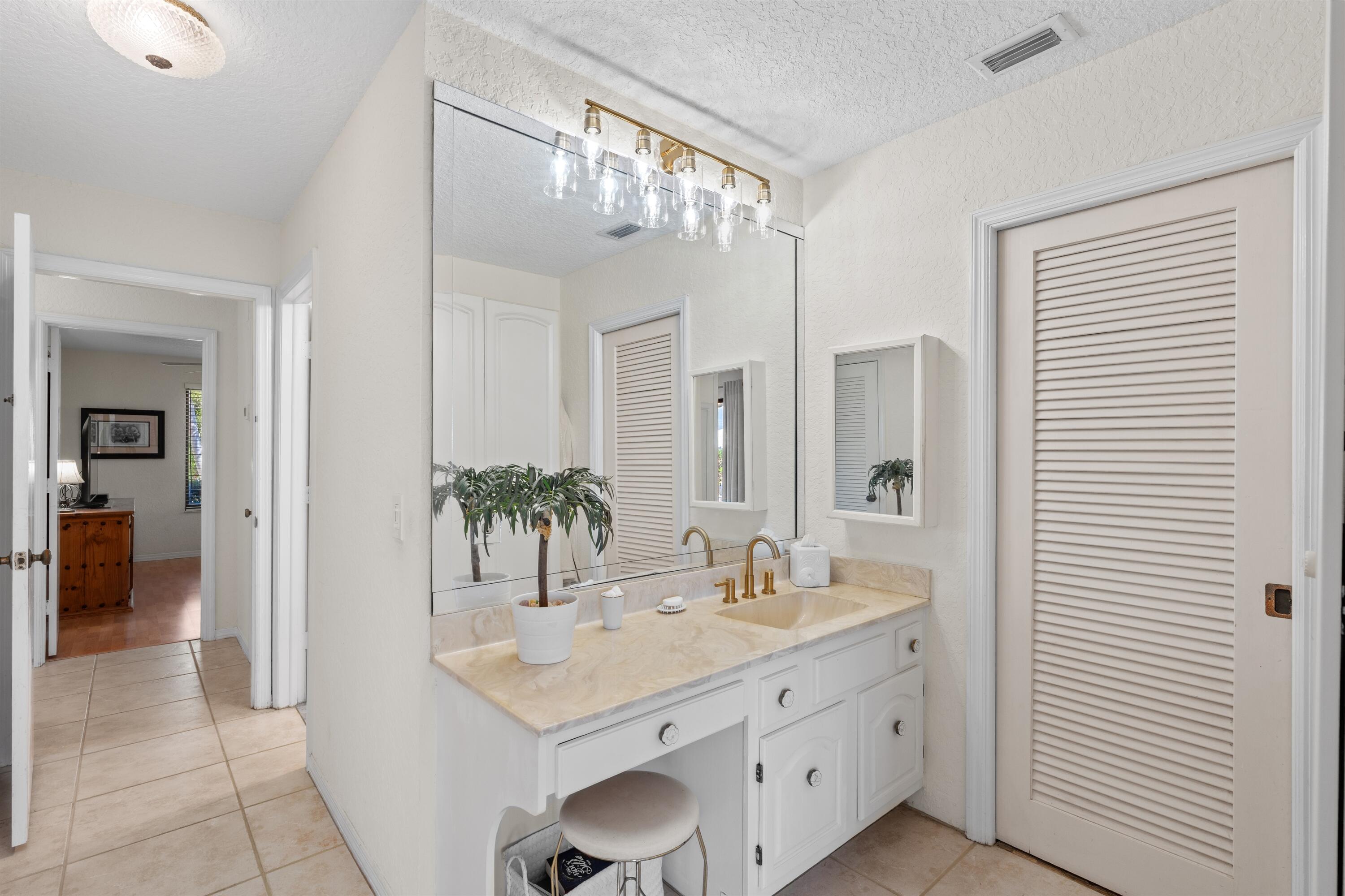 1223 Pepperridge Terrace Boca Raton, FL 33486 - Photo 17 of 34 a bathroom with a granite countertop sink and a mirror