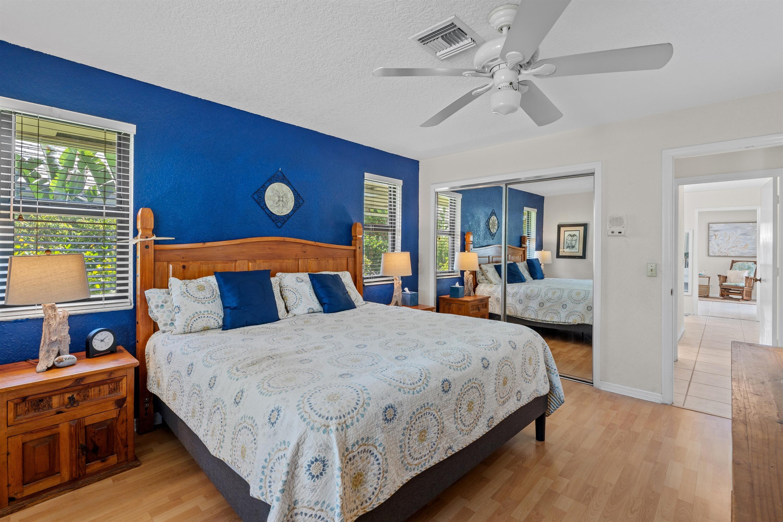 1223 Pepperridge Terrace Boca Raton, FL 33486 - Photo 19 of 34 a bedroom with a large bed and a chandelier